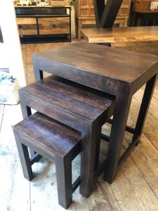 side profile of nest of 3 tables of dark wood